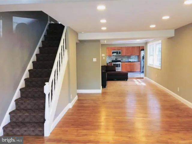 a view of a living room with furniture and a fireplace