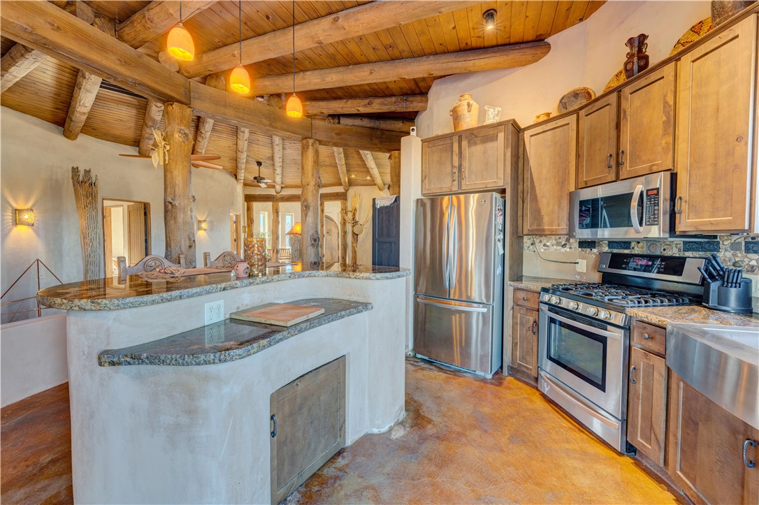 17445 South La Cienega Ranch Road Yucca, AZ 86438 - Photo 12 of 52 a kitchen with stainless steel appliances granite countertop a sink a stove and a refrigerator