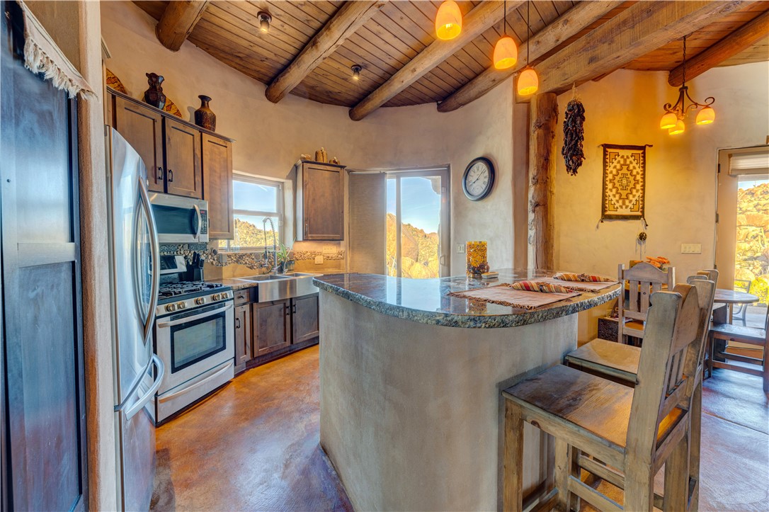 17445 South La Cienega Ranch Road Yucca, AZ 86438 - Photo 15 of 52 a view of a kitchen with stainless steel appliances granite countertop a stove and a refrigerator