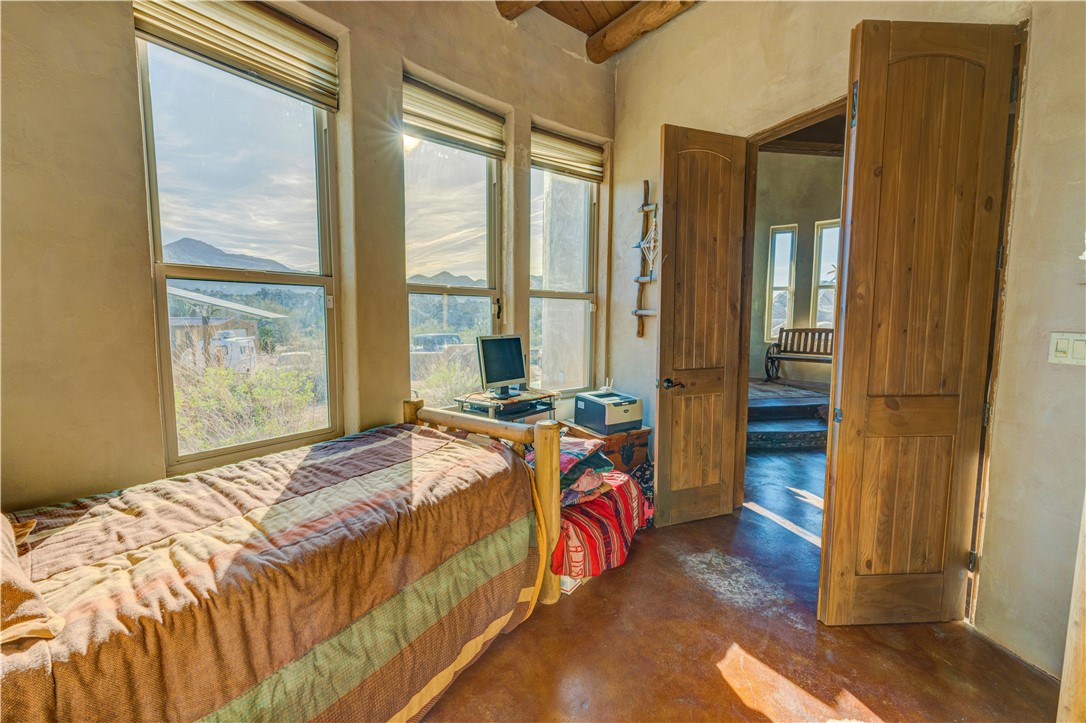 17445 South La Cienega Ranch Road Yucca, AZ 86438 - Photo 17 of 52 a bed sitting in a bedroom next to a window