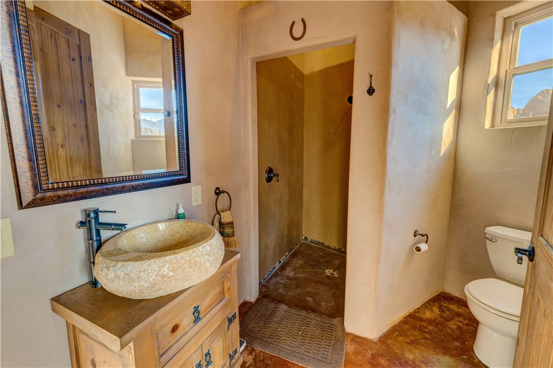 17445 South La Cienega Ranch Road Yucca, AZ 86438 - Photo 18 of 52 a bathroom with a granite countertop sink and a mirror