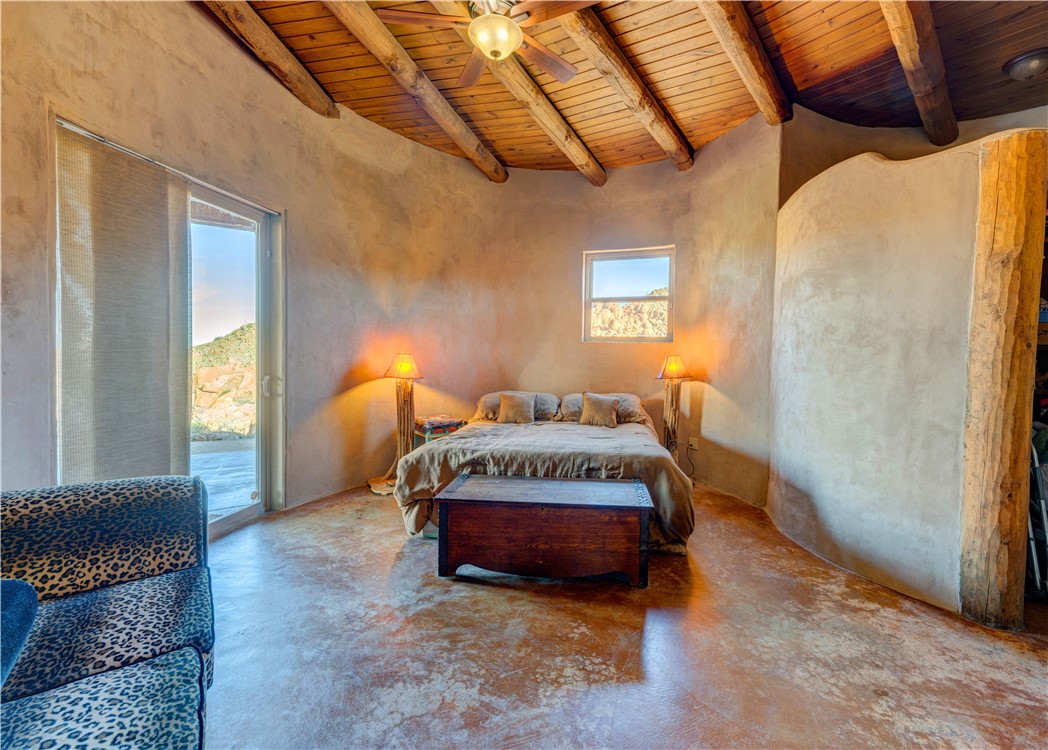 17445 South La Cienega Ranch Road Yucca, AZ 86438 - Photo 19 of 52 a spacious bedroom with a bed and a window