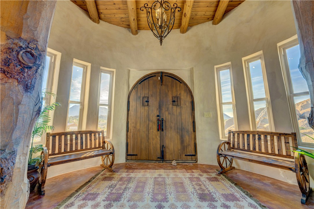 17445 South La Cienega Ranch Road Yucca, AZ 86438 - Photo 3 of 52 a view of a porch with wooden floor and a floor to ceiling window
