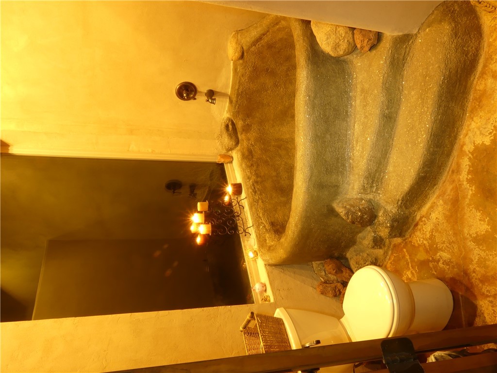 17445 South La Cienega Ranch Road Yucca, AZ 86438 - Photo 50 of 52 a bathroom with a toilet sink and mirror