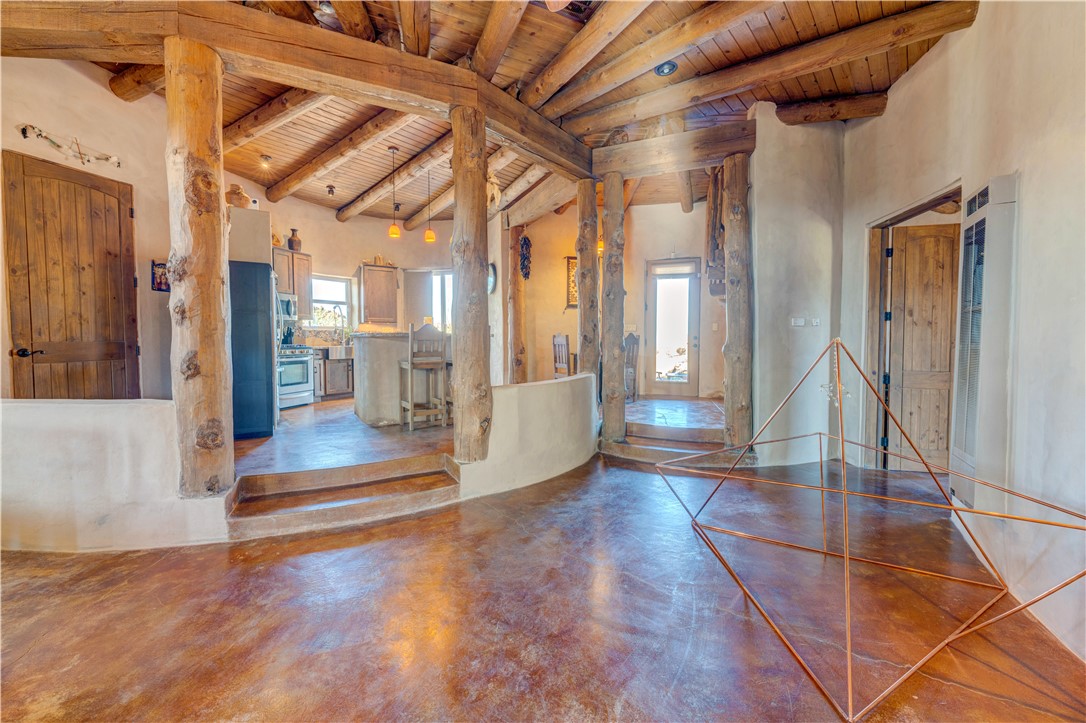 17445 South La Cienega Ranch Road Yucca, AZ 86438 - Photo 8 of 52 a view of a hallway with wooden floor and a living room