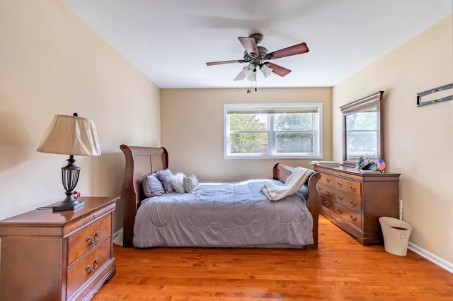 a bedroom with a bed window and a table