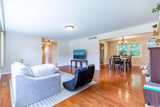 a kitchen with stainless steel appliances granite countertop a refrigerator a sink a stove top oven and granite countertops