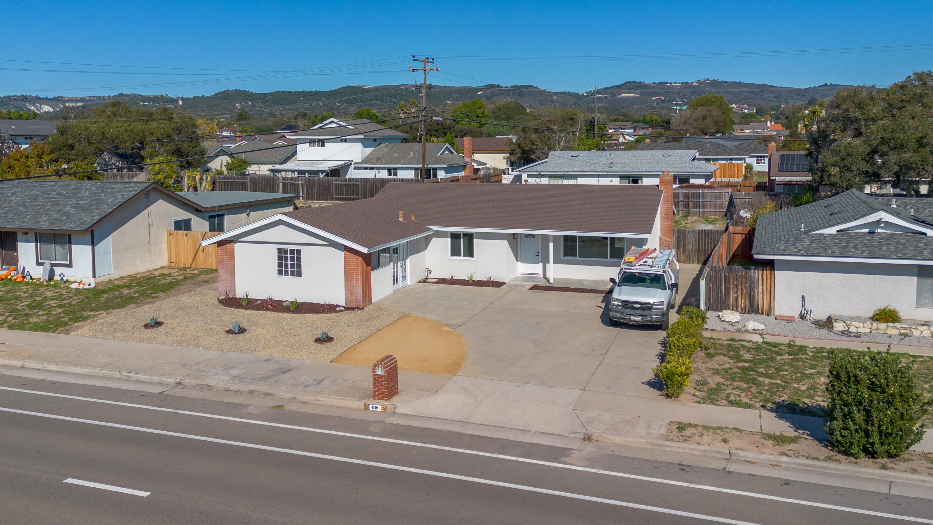 an aerial view of residential houses with outdoor space