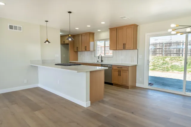 a kitchen with a sink window and cabinets