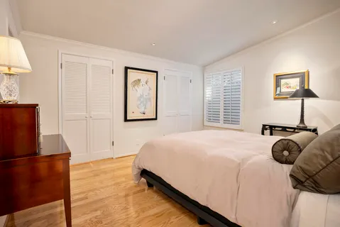 a bedroom with a bed and a refrigerator