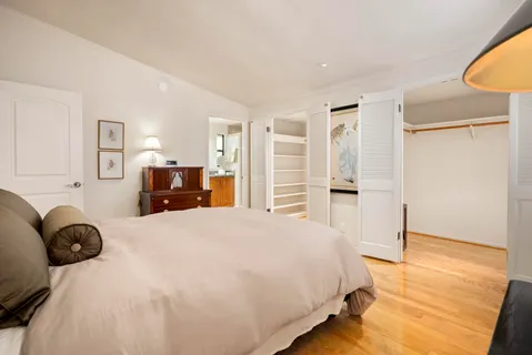 a bedroom with a bed and cabinets