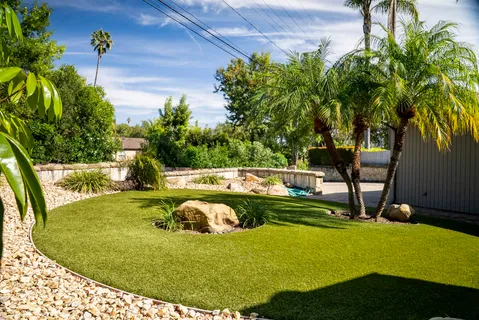 a view of a swimming pool with a yard