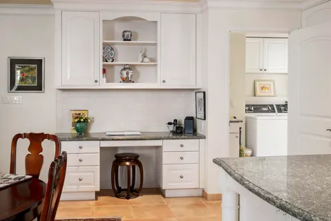 a kitchen with stainless steel appliances granite countertop a sink and wooden cabinets