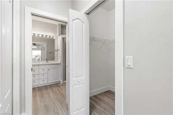 a large bed sitting in a bedroom next to a window