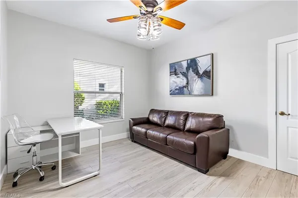 a dining room with furniture and a floor to ceiling window