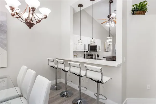 a view of a dining room with furniture wooden floor and a chandelier