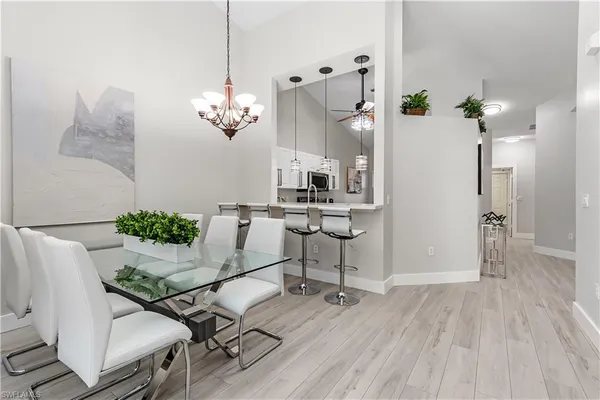 a view of a dining room with furniture wooden floor and chandelier