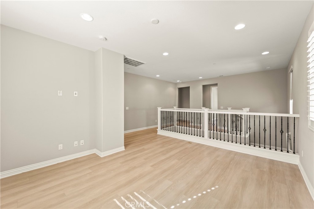9719 La Vine Court Rancho Cucamonga, CA 91701 - Photo 11 of 39 an empty room with wooden floor and fence