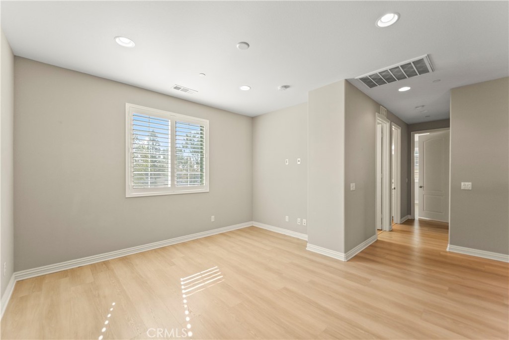 9719 La Vine Court Rancho Cucamonga, CA 91701 - Photo 12 of 39 a view of an empty room with wooden floor and a window