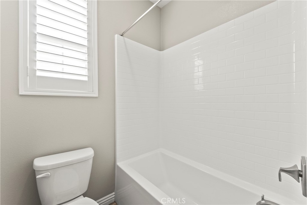 9719 La Vine Court Rancho Cucamonga, CA 91701 - Photo 16 of 39 a white toilet sitting next to a bath tub