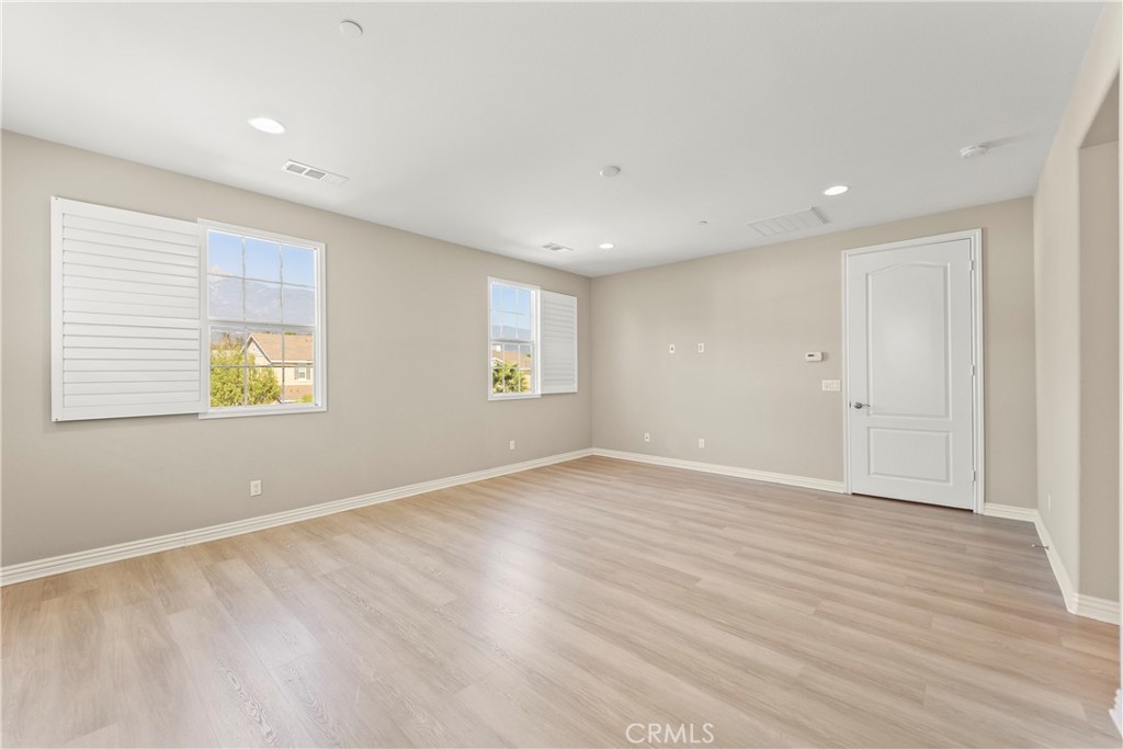 9719 La Vine Court Rancho Cucamonga, CA 91701 - Photo 20 of 39 an empty room with wooden floor and windows