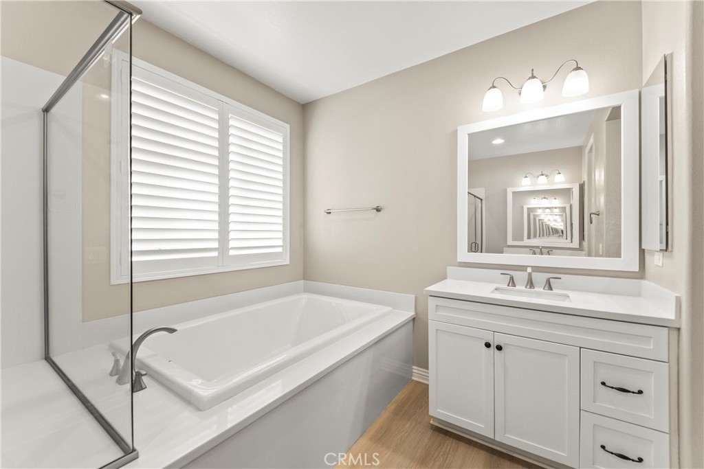 9719 La Vine Court Rancho Cucamonga, CA 91701 - Photo 23 of 39 a bathroom with a tub sink and mirror