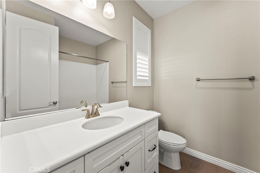 9719 La Vine Court Rancho Cucamonga, CA 91701 - Photo 28 of 39 a bathroom with a sink toilet and vanity