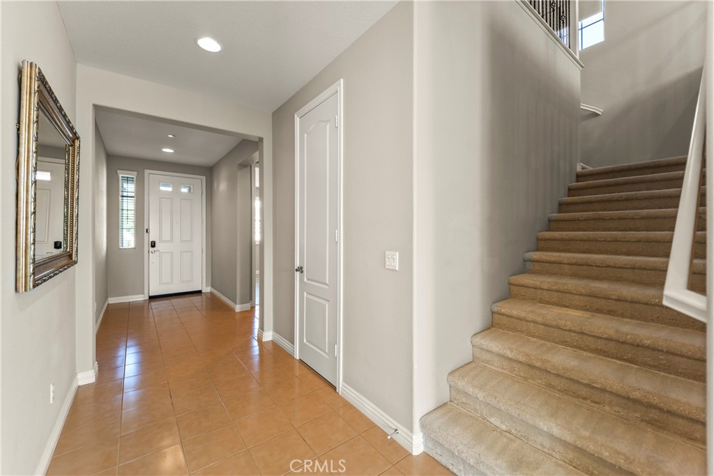 9719 La Vine Court Rancho Cucamonga, CA 91701 - Photo 3 of 39 a view of a hallway with wooden floor and entryway