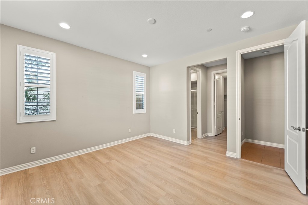 9719 La Vine Court Rancho Cucamonga, CA 91701 - Photo 32 of 39 an empty room with wooden floor and windows