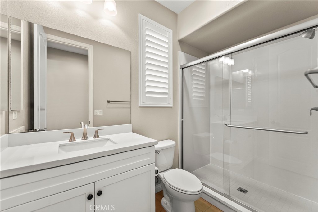 9719 La Vine Court Rancho Cucamonga, CA 91701 - Photo 33 of 39 a bathroom with a shower sink vanity mirror and toilet