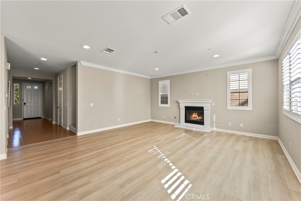 9719 La Vine Court Rancho Cucamonga, CA 91701 - Photo 4 of 39 a view of an empty room with wooden floor and a window
