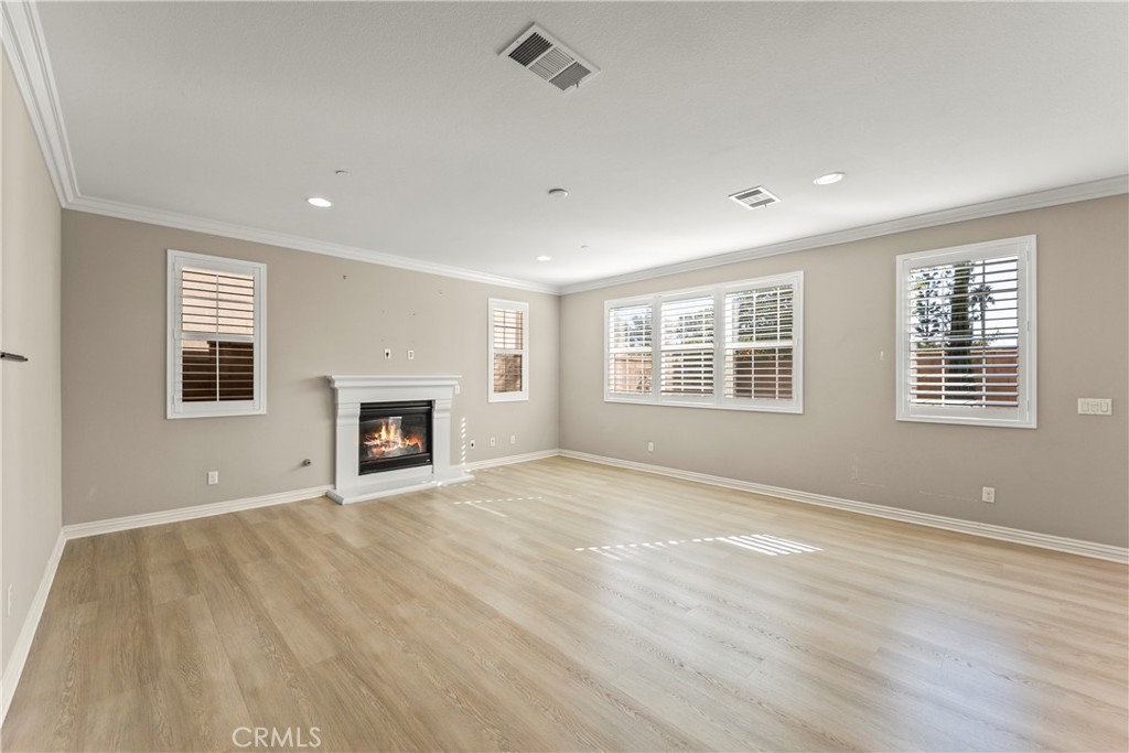 9719 La Vine Court Rancho Cucamonga, CA 91701 - Photo 5 of 39 a view of empty room with wooden floor and fireplace