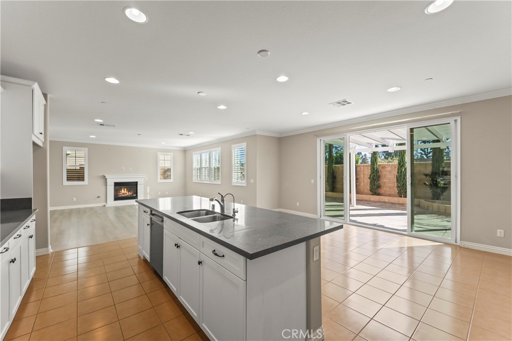 9719 La Vine Court Rancho Cucamonga, CA 91701 - Photo 9 of 39 a kitchen with granite countertop a sink and cabinets