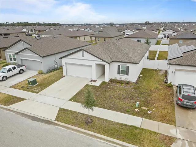 an aerial view of a house with a yard