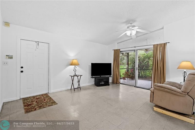 Timberwalk Boca Raton, FL 33428 - Photo 8 of 35 a living room with furniture a flat screen tv and a large window