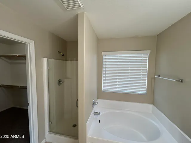 a bathroom with a bathtub and a shower