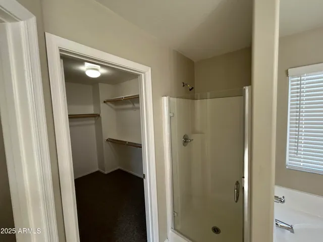 a bathroom with a shower and a sink