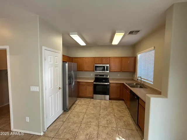 a kitchen with stainless steel appliances a refrigerator and a stove