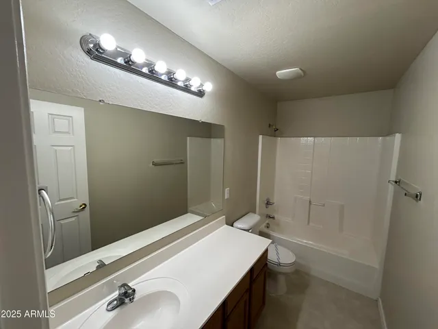a bathroom with a sink a shower and a mirror