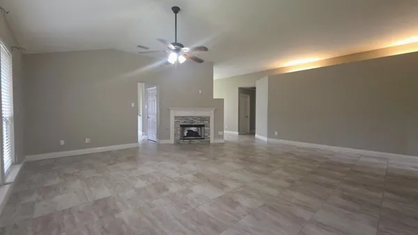 a view of an empty room with a fireplace