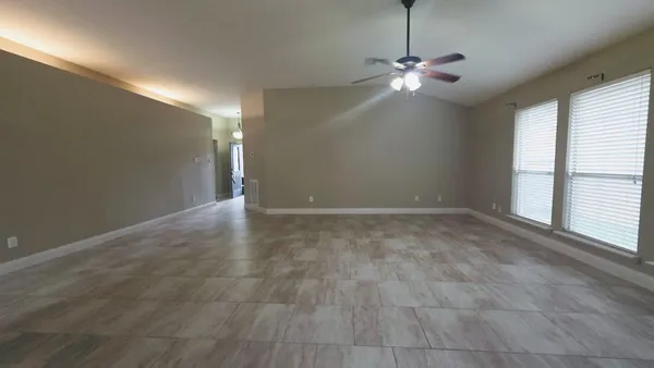 a view of a livingroom with a ceiling fan and window
