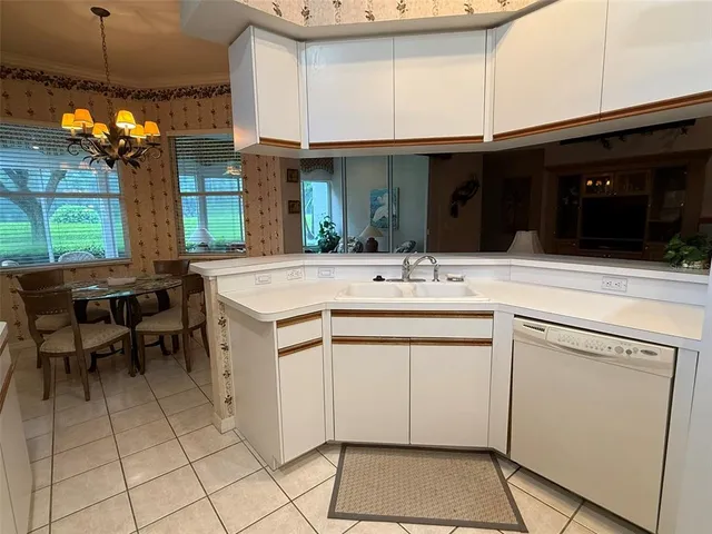 a kitchen with a sink cabinets and window