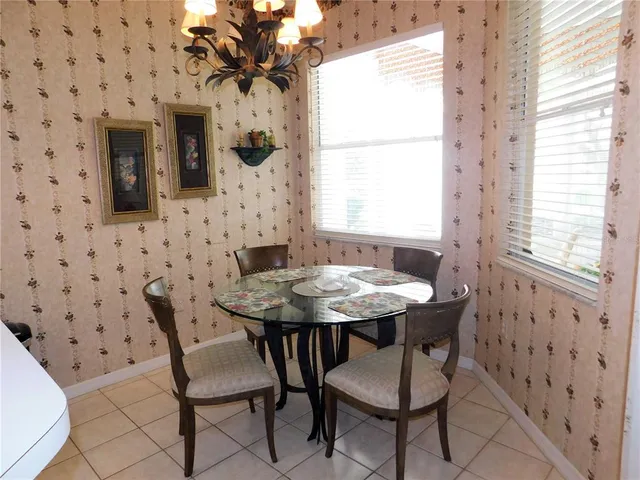 a view of a dining room with furniture and window