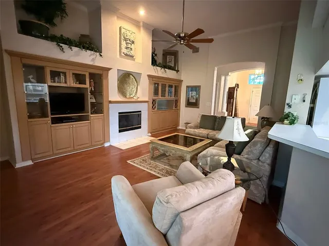 a living room with furniture fireplace and flat screen tv