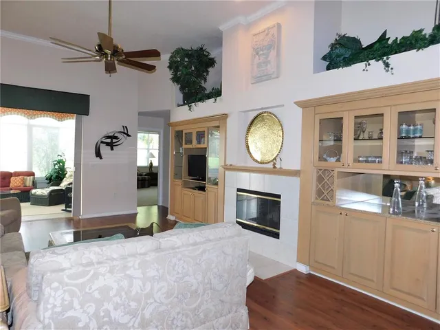 a living room with furniture a fireplace and a potted plant