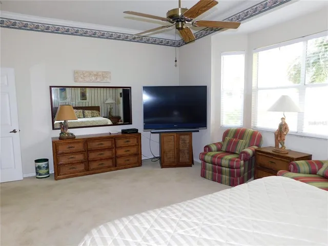 a bedroom with furniture and a flat screen tv