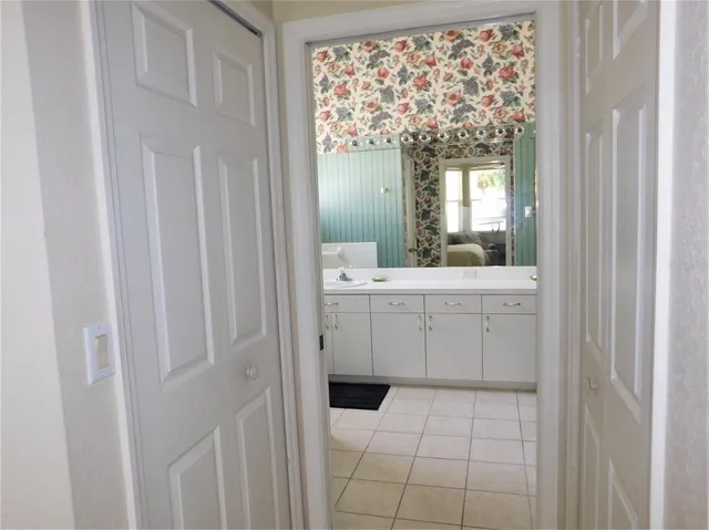 a bathroom with a sink a mirror and next to a window