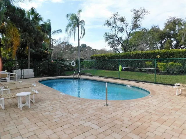 a view of a swimming pool with a lounge chair