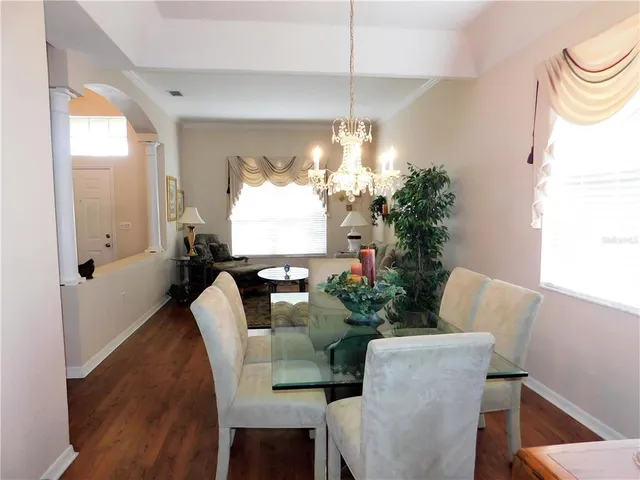 a view of a dining room with furniture window and wooden floor