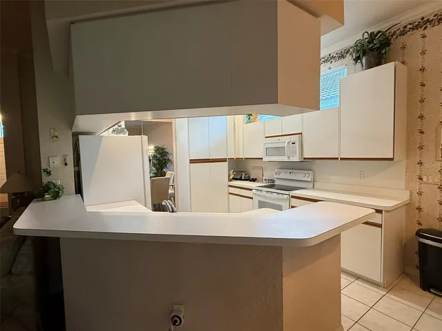 a kitchen with a sink a stove and a refrigerator